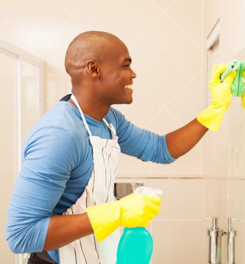 young-black-man-cleaning-mirror